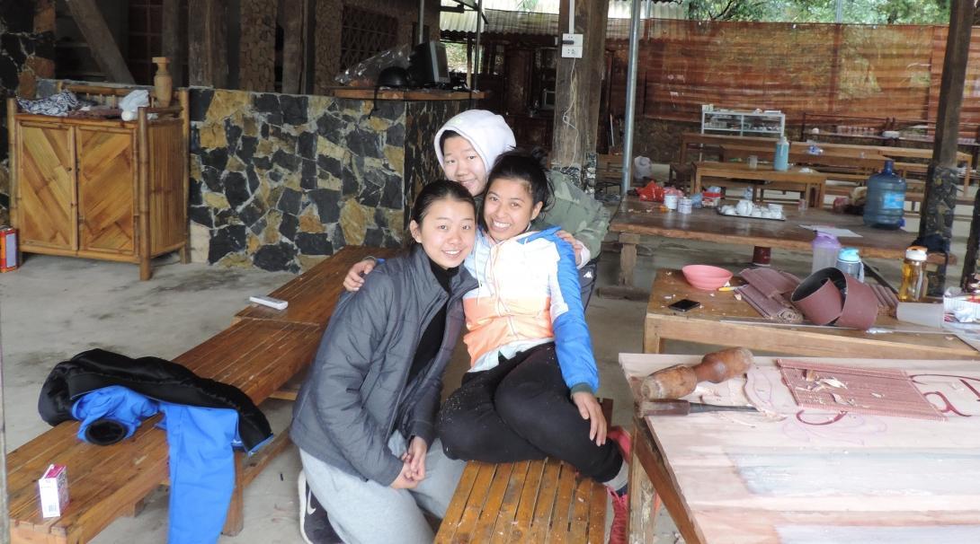 Female Projects Abroad Business Interns pose or a picture in a local arts centre during their Business Internship in Vietnam. Female Business interns pose for a picture whilst at an Art Centre used for making products during their placement in Vietnam.
